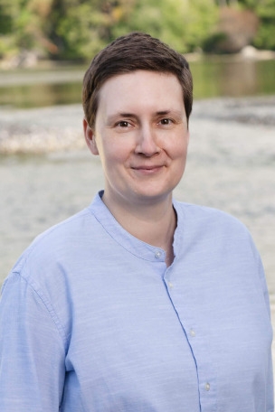 Ivana Kvartuc standing on the beach in a light blue shirt
