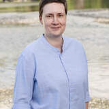 Ivana Kvartuc standing on the beach in a light blue shirt